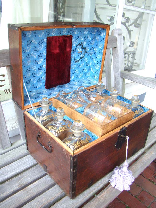 An important late 18th century iron bound oak travelling liquor chest belonging to Gen. Abraham Rose of Long Island having its original and complete set of gilded hand blown glass decanters(12), tumblers, funnel and wine glasses. Spanish circa 1790. 